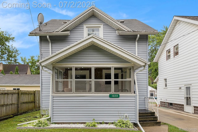 1323 Rhodes St, Jackson, MI 49202 - view of front of house featuring a sunroom and roof with shingles