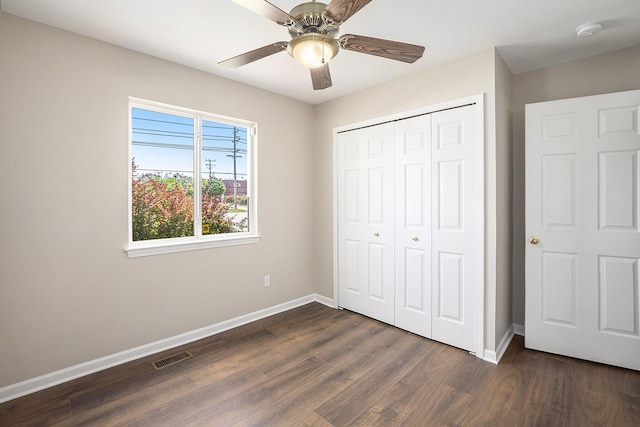 46317 Dequindre Rd, Rochester Hills, MI 48307 - unfurnished bedroom with dark wood-style flooring, a closet, and a ceiling fan