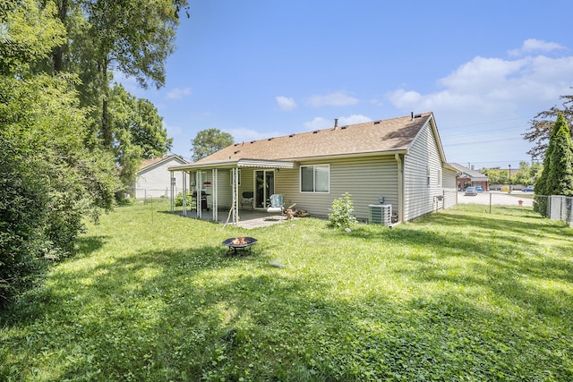 46317 Dequindre Rd, Rochester Hills, MI 48307 - back of property featuring a fire pit, a patio area, a fenced backyard, and roof with shingles