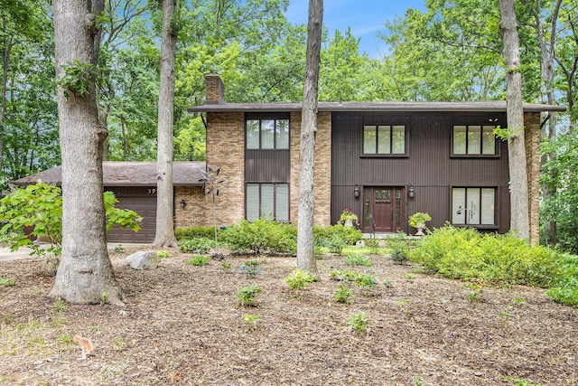 3924 Penberton Dr, Ann Arbor, MI 48105 - view of front facade featuring a chimney and an attached garage