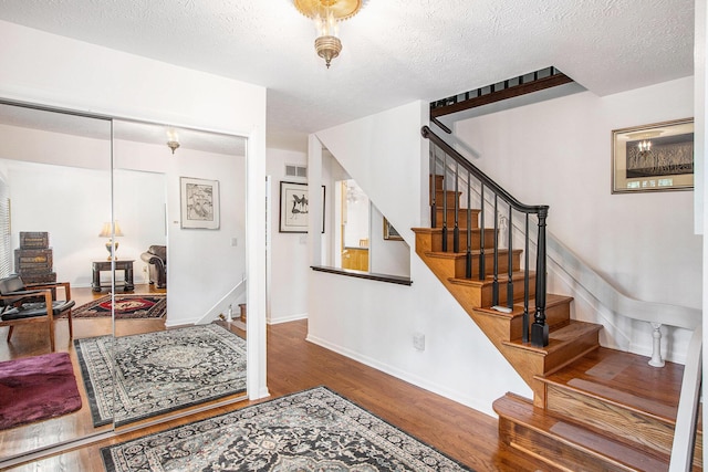 3924 Penberton Dr, Ann Arbor, MI 48105 - foyer with wood finished floors, stairs, and a textured ceiling