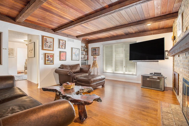 3924 Penberton Dr, Ann Arbor, MI 48105 - living area with a wooden ceiling with exposed beams, a brick fireplace, and wood finished floors