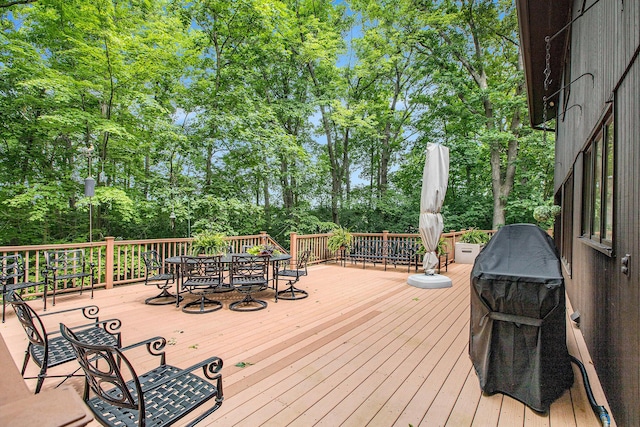 3924 Penberton Dr, Ann Arbor, MI 48105 - wooden terrace with outdoor dining space, view of wooded area, and grilling area