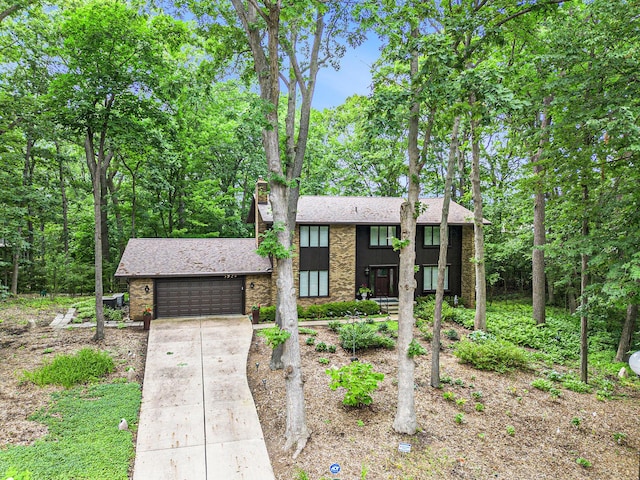 3924 Penberton Dr, Ann Arbor, MI 48105 - view of front of home with an attached garage, concrete driveway, brick siding, and a shingled roof