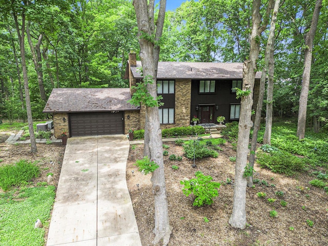 3924 Penberton Dr, Ann Arbor, MI 48105 - view of front of property with an attached garage, concrete driveway, a chimney, a shingled roof, and brick siding