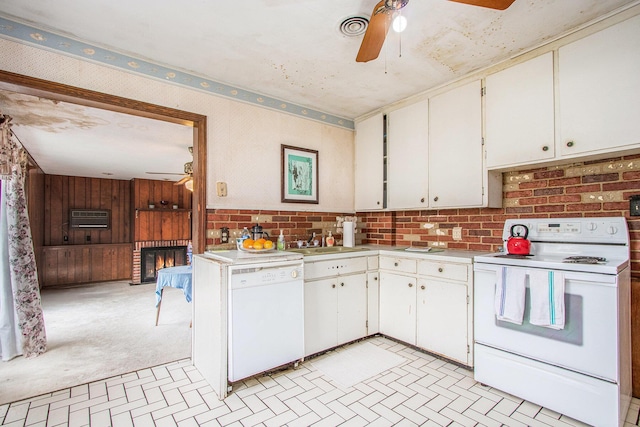 1209 Mohawk Ln, Saint Joseph, MI 49085 - kitchen with white appliances, ceiling fan, light countertops, a glass covered fireplace, and brick patterned flooring