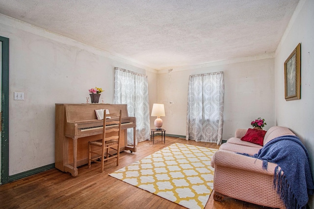 1209 Mohawk Ln, Saint Joseph, MI 49085 - living room featuring a textured ceiling, wood finished floors, and crown molding