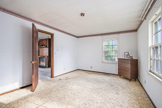 1209 Mohawk Ln, Saint Joseph, MI 49085 - unfurnished room featuring carpet flooring, ornamental molding, and a fireplace