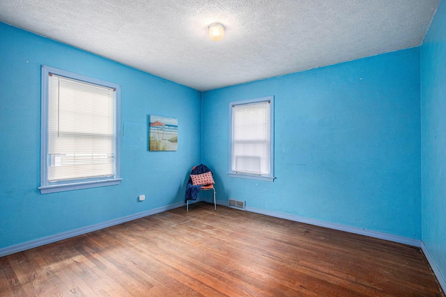 1209 Mohawk Ln, Saint Joseph, MI 49085 - empty room with a textured ceiling and wood finished floors