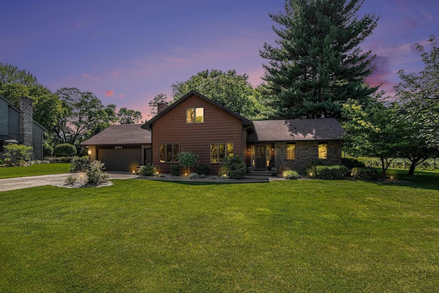 4102 Tomahawk Way, Saint Joseph, MI 49085 - view of front of home with concrete driveway, a yard, a garage, and a chimney