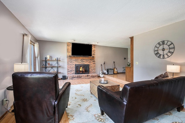 4102 Tomahawk Way, Saint Joseph, MI 49085 - living room featuring a brick fireplace, wood finished floors, and a textured ceiling