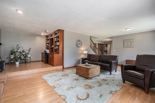 4102 Tomahawk Way, Saint Joseph, MI 49085 - living room with a textured ceiling, wood finished floors, and stairs