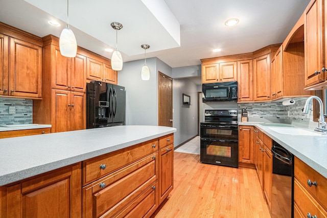 4102 Tomahawk Way, Saint Joseph, MI 49085 - kitchen featuring black appliances, decorative backsplash, light countertops, pendant lighting, and recessed lighting