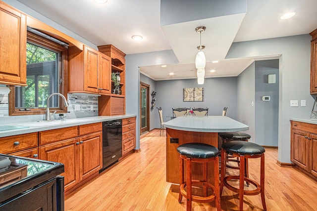 4102 Tomahawk Way, Saint Joseph, MI 49085 - kitchen featuring black dishwasher, light wood-style floors, brown cabinetry, a breakfast bar area, and recessed lighting