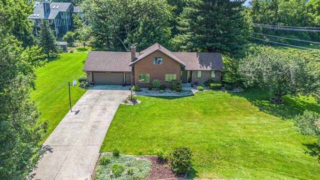 4102 Tomahawk Way, Saint Joseph, MI 49085 - view of front of property with a chimney, a front yard, driveway, and an attached garage