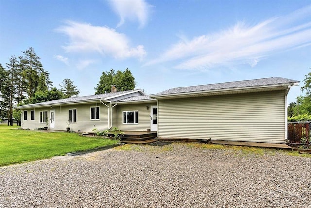 534 S Main St, Au Gres, MI 48703 - back of house featuring a lawn and a wooden deck