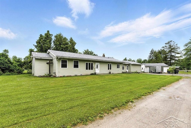 534 S Main St, Au Gres, MI 48703 - ranch-style home featuring dirt driveway, a front yard, and a chimney