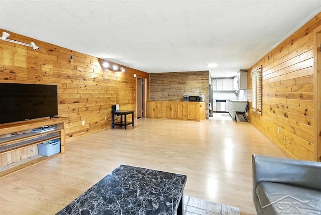 534 S Main St, Au Gres, MI 48703 - living room with wooden walls and light wood-type flooring