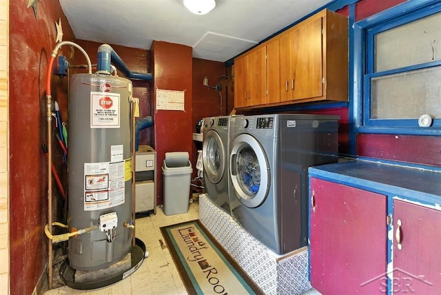 534 S Main St, Au Gres, MI 48703 - laundry room with gas water heater, cabinet space, tile patterned floors, and washer and clothes dryer