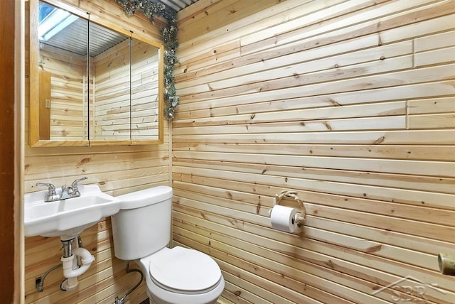 534 S Main St, Au Gres, MI 48703 - bathroom featuring wooden walls and toilet