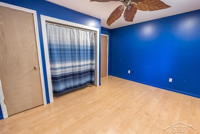 534 S Main St, Au Gres, MI 48703 - empty room with ceiling fan and wood finished floors