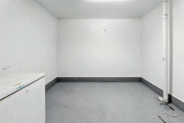534 S Main St, Au Gres, MI 48703 - empty room featuring finished concrete flooring and baseboards