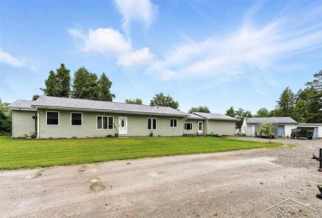 534 S Main St, Au Gres, MI 48703 - ranch-style house with a front yard, a chimney, and driveway