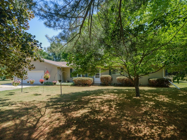 461 19th St, Otsego, MI 49078 - view of front of home with an attached garage, a front yard, and concrete driveway