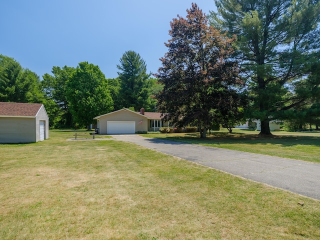 461 19th St, Otsego, MI 49078 - view of front facade with driveway, a front lawn, an attached garage, and a chimney