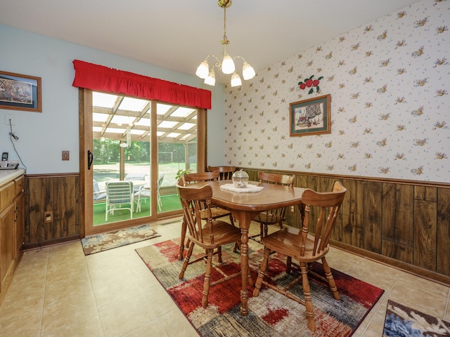 461 19th St, Otsego, MI 49078 - dining area featuring a wainscoted wall, a chandelier, wood walls, and light tile patterned floors
