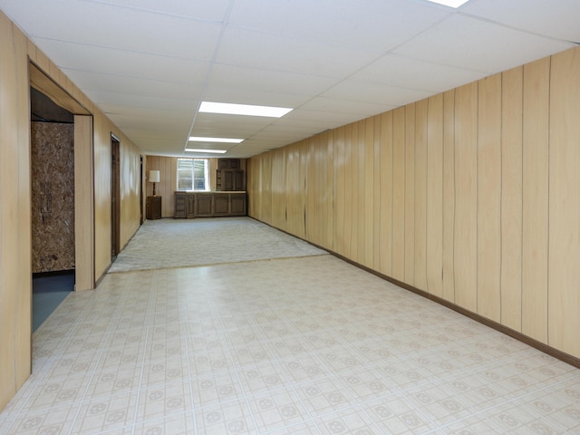 461 19th St, Otsego, MI 49078 - unfurnished room featuring light floors, wood walls, and a paneled ceiling