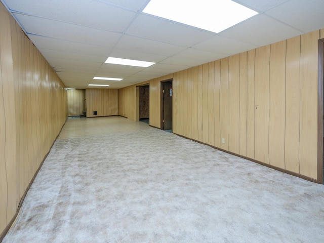 461 19th St, Otsego, MI 49078 - finished below grade area featuring a paneled ceiling, wood walls, and light carpet