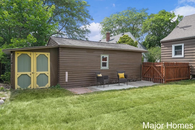 860 Beech St SW, Wyoming, MI 49509 - rear view of house with a shed, a chimney, roof with shingles, a patio area, and a gate