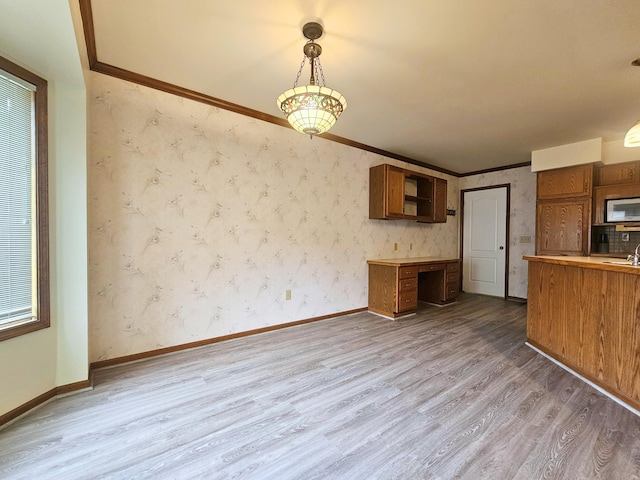5546 Hickory Cir, Flushing, MI 48433 - kitchen featuring wood finished floors, brown cabinetry, decorative light fixtures, open shelves, and built in desk