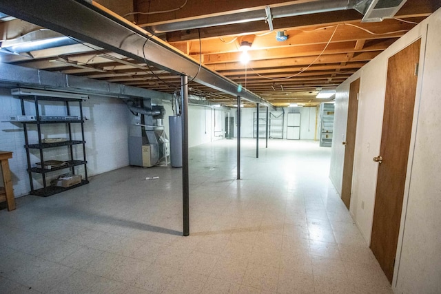 5546 Hickory Cir, Flushing, MI 48433 - unfinished below grade area featuring heating unit, tile patterned floors, and water heater