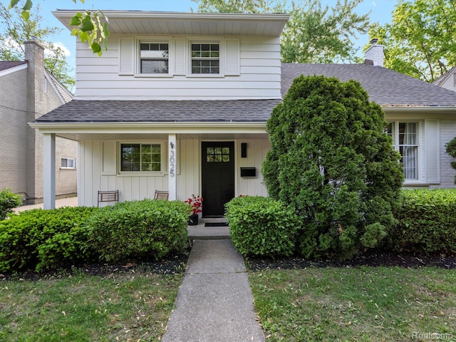 3025 Clawson Ave, Royal Oak, MI 48073 - view of front of property with a shingled roof, covered porch, board and batten siding, and a chimney