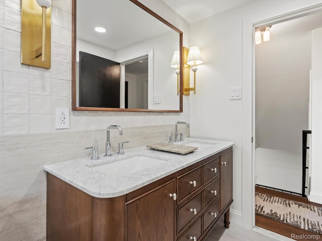 3025 Clawson Ave, Royal Oak, MI 48073 - bathroom featuring double vanity and backsplash
