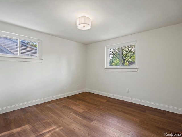 3025 Clawson Ave, Royal Oak, MI 48073 - unfurnished room with baseboards and dark wood-style flooring