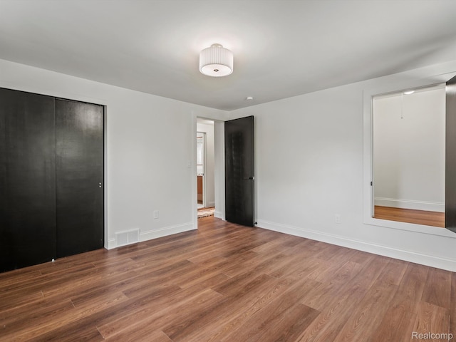 3025 Clawson Ave, Royal Oak, MI 48073 - unfurnished bedroom featuring wood finished floors and a closet
