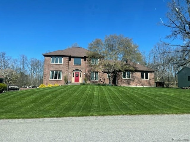 472 Ashton Ct SE, Grand Rapids, MI 49546 - colonial inspired home with a front lawn and brick siding
