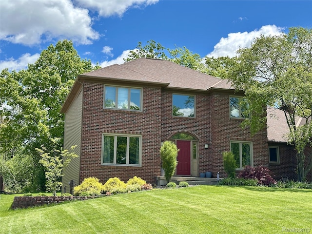 472 Ashton Ct SE, Grand Rapids, MI 49546 - view of front of home featuring a front yard, brick siding, and a shingled roof