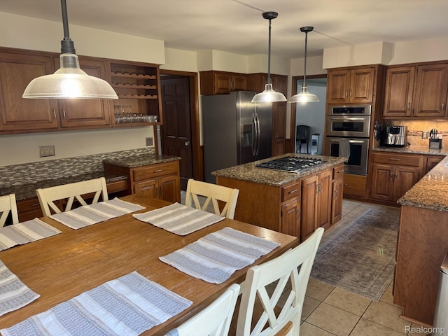 472 Ashton Ct SE, Grand Rapids, MI 49546 - kitchen with appliances with stainless steel finishes, open shelves, a kitchen island, light tile patterned floors, and dark stone countertops