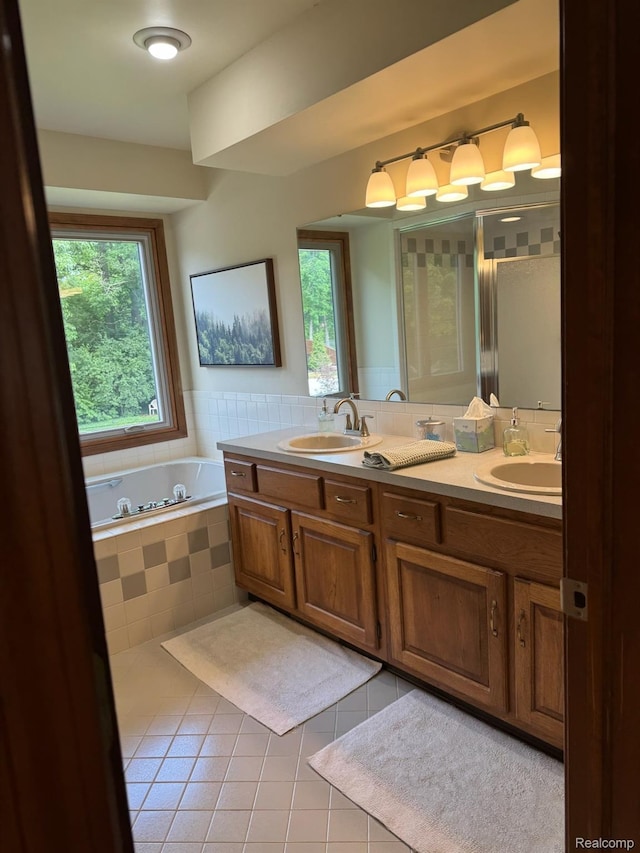 472 Ashton Ct SE, Grand Rapids, MI 49546 - bathroom featuring double vanity, tile patterned flooring, and a bath