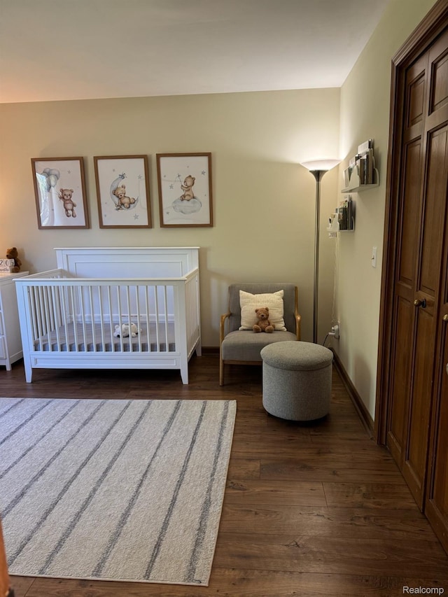 472 Ashton Ct SE, Grand Rapids, MI 49546 - bedroom with dark wood-style floors and a crib