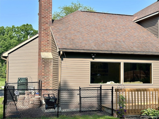 472 Ashton Ct SE, Grand Rapids, MI 49546 - view of property exterior with a chimney and roof with shingles
