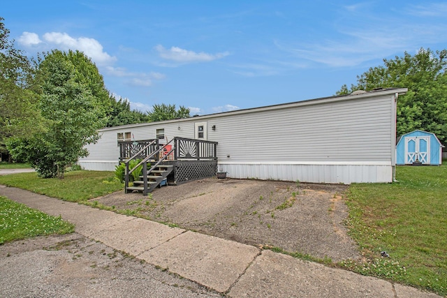 1950 S 13th, Niles, MI 49120 - manufactured / mobile home with a storage unit, a wooden deck, and a front yard