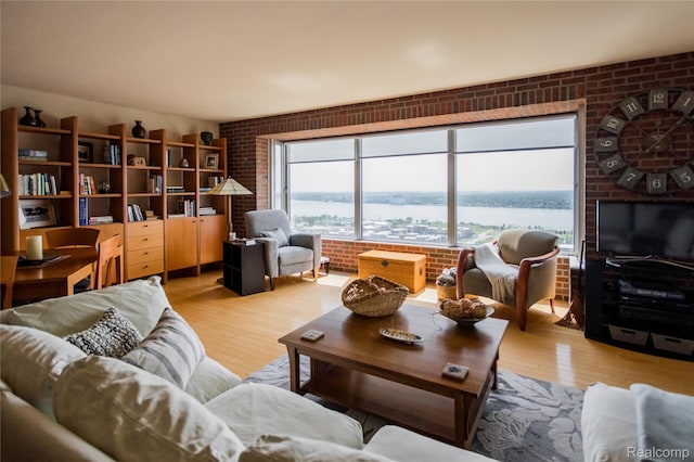 1300 E Lafayette St Unit 2503, Detroit, MI 48207 - living area with brick wall and wood finished floors