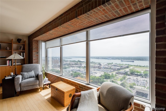 1300 E Lafayette St Unit 2503, Detroit, MI 48207 - sunroom with hardwood / wood-style flooring, a water view, and brick wall