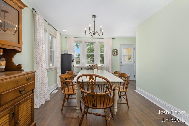 1802 Cherry St, Dorr, MI 49323 - dining room with a chandelier and dark wood-style floors