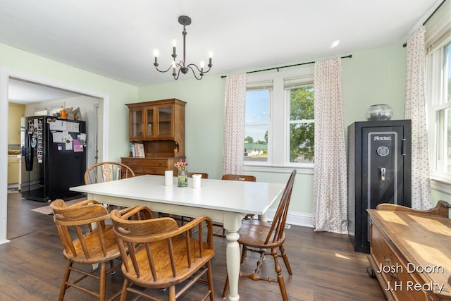 1802 Cherry St, Dorr, MI 49323 - dining space with a chandelier and dark wood-style floors